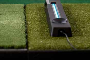 NOVA launch monitor close-up showing blue LED indicator, touch controls