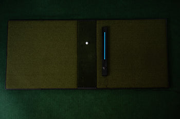 NOVA Golf Entertainment System top-down view on hitting mat with blue LED sensor light active